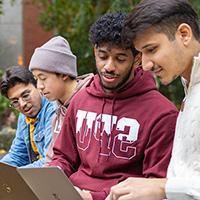 SPU students work on their laptops in Martin Square on campus